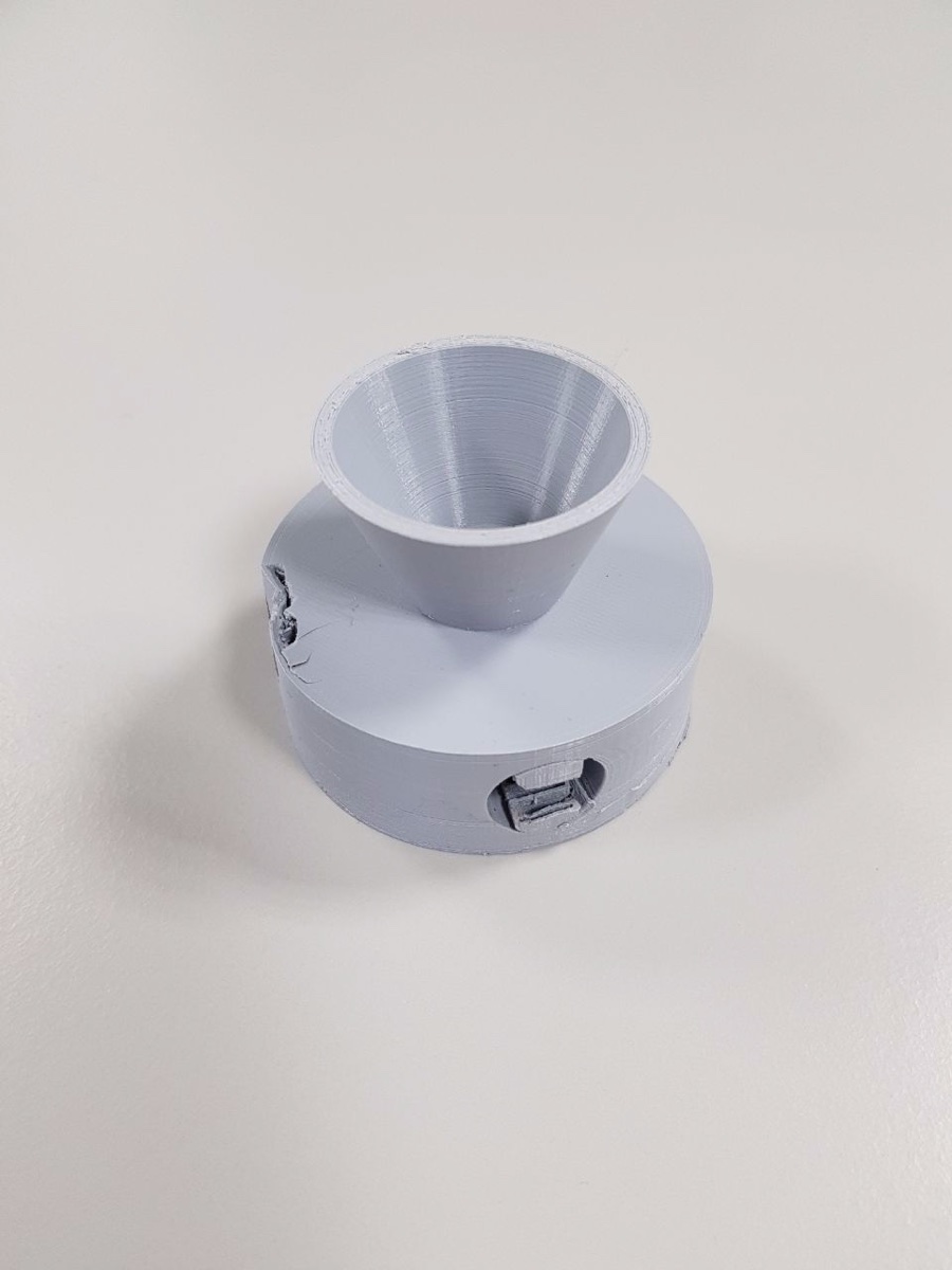 3D-printed funnel horn seated in its circular base