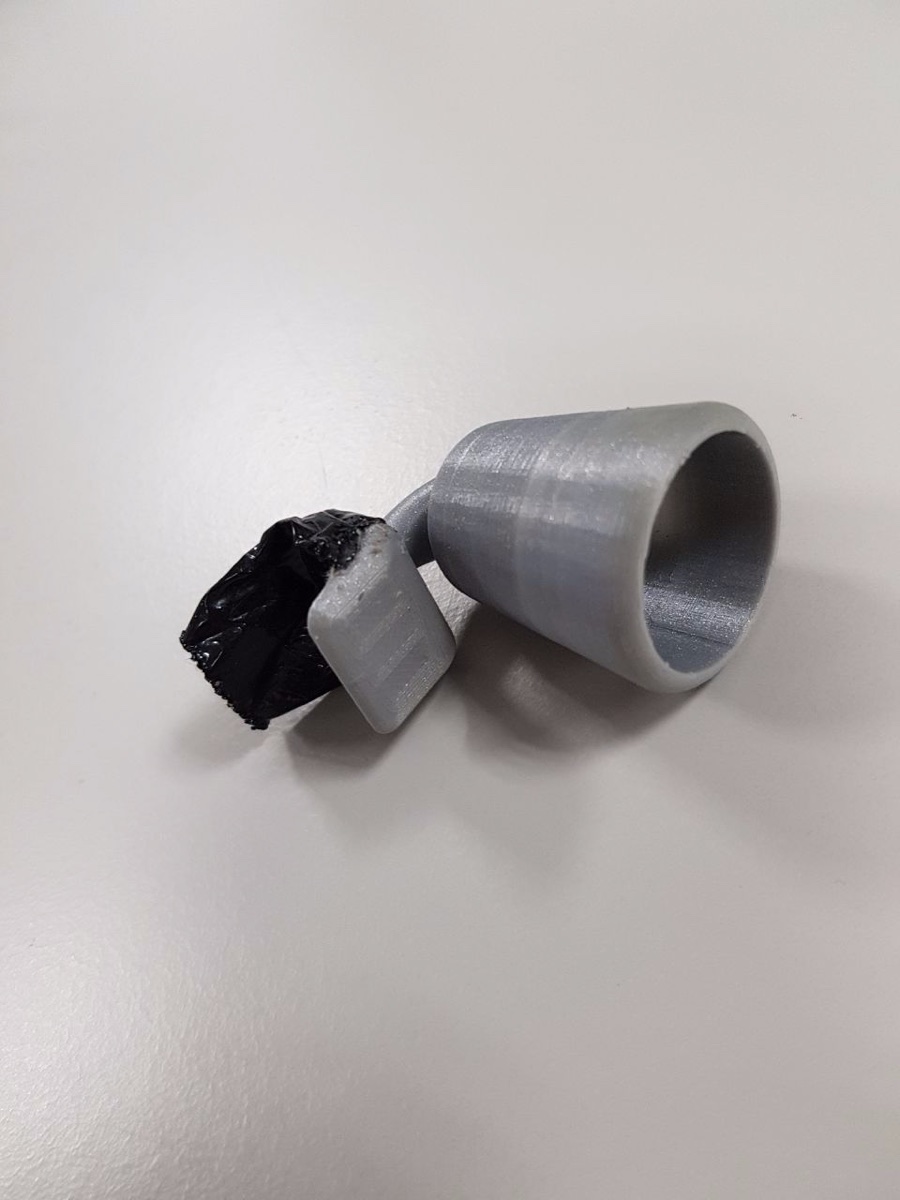 3D-printed horn next to the taped electronics module