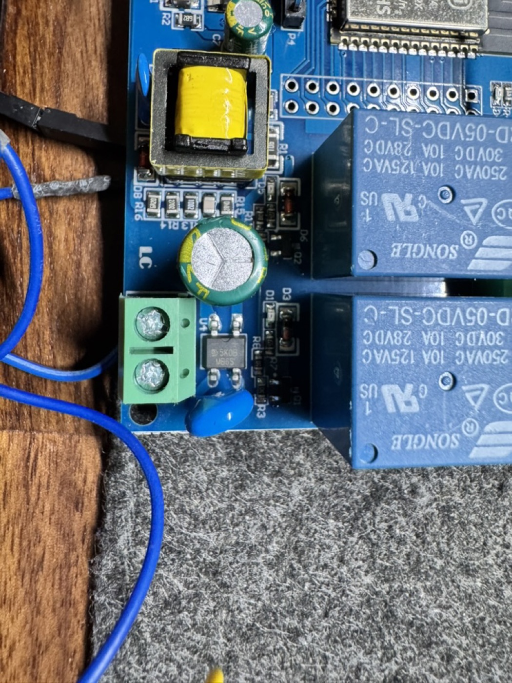 Close-up of the relay board wiring: the screw terminal and relays that mimic the wall button press